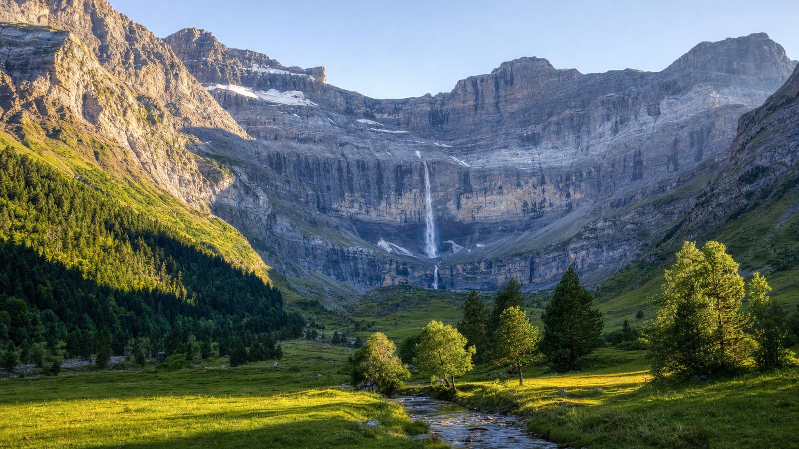 Mountain lake ringed by granite peaks in the French Pyrenees on a clear summer morning, near the Spanish border